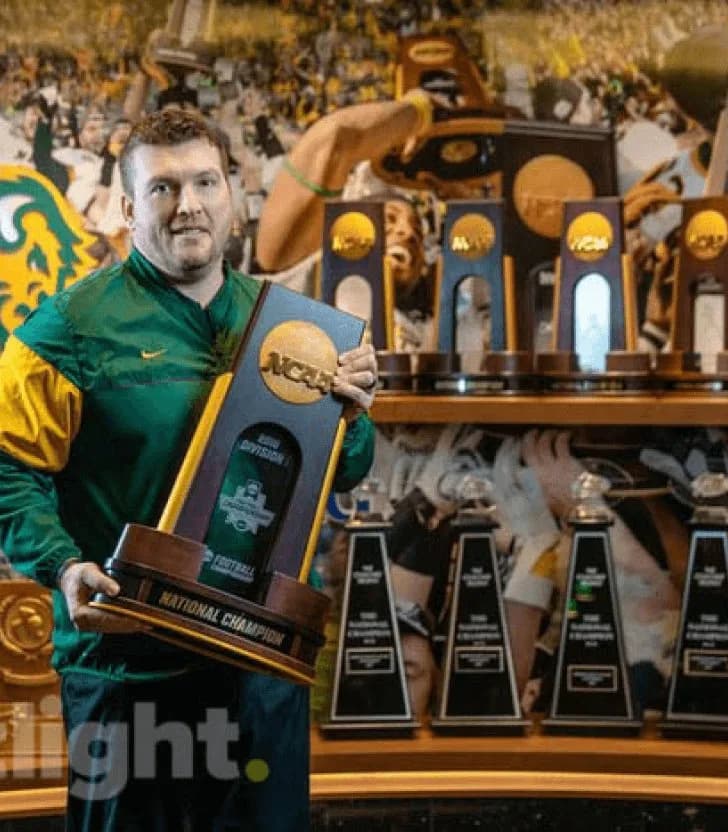 NDSU athlete holding a championship trophy
